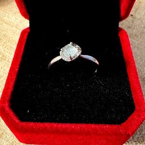Raw aquamarine ring with diamond accents set in sterling silver